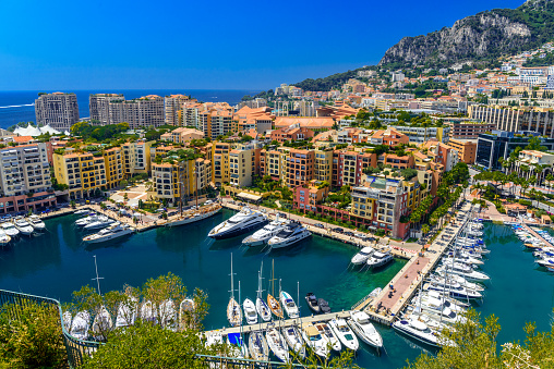 Yachts in bay near houses and hotels, Fontvielle, Monte-Carlo, Monaco, Cote d'Azur, French Riviera.