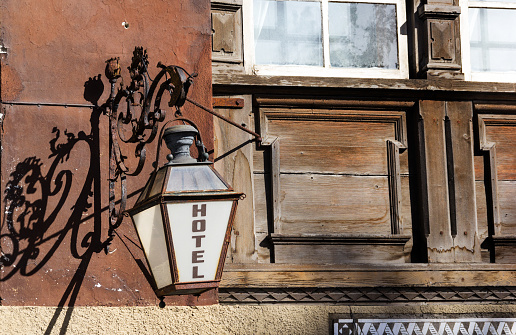 Vintage hotel sign on an old house with wooden window
