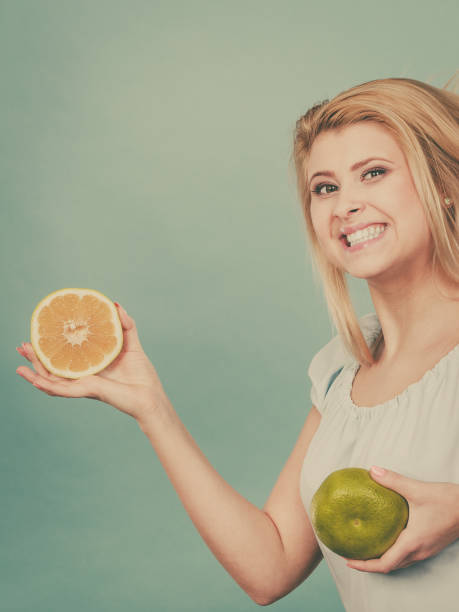 istock Woman holding fruit green grapefruit 1140849447