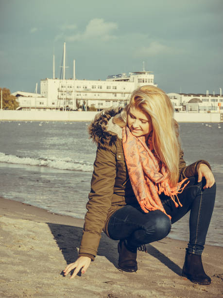 istock Woman relaxing on beach, cold day 1140850061