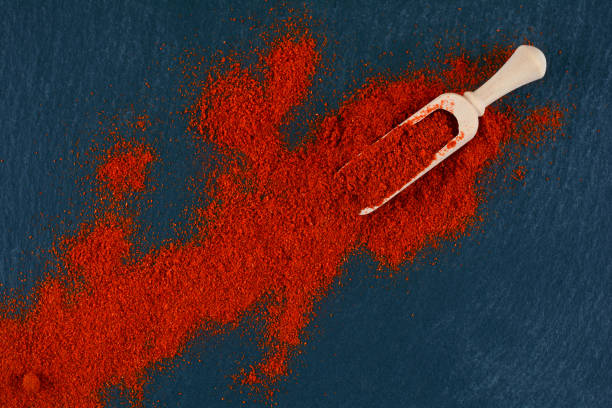 istock Dry powder paprika on slate background 1140851464