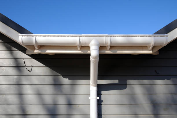 istock New rain gutter on a home against blue sky. 1140851651
