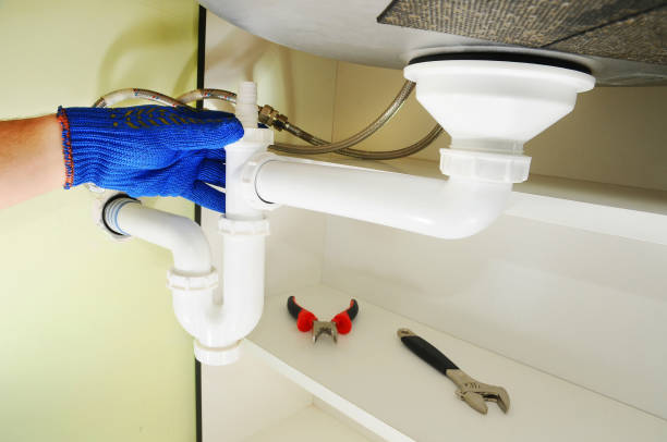 istock Plumber fixing the sink siphon in a kitchen. 1140851764