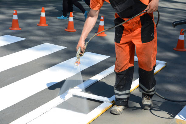 istock Worker is painting a pedestrian crosswalk. 1140852580