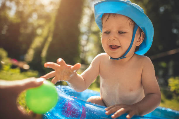 istock Cute little boy having fun in swimming pool at back yard in summer 1140854843