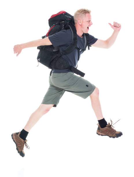 istock Attractive young male hiker running and jumping 1140856051