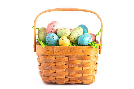 A Wooden Easter Basket Filled with Decorated Eggs Isolated on a White Background