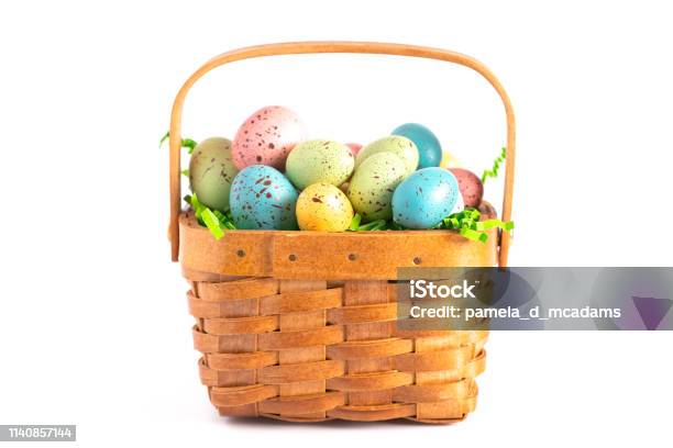 A Wooden Easter Basket Filled With Decorated Eggs Isolated On A White Background Stock Photo - Download Image Now