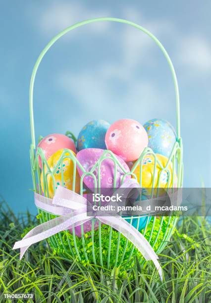 An Easter Basket Filled With Diecorated Eggs On A Clear Blue Sky Spring Day Stock Photo - Download Image Now