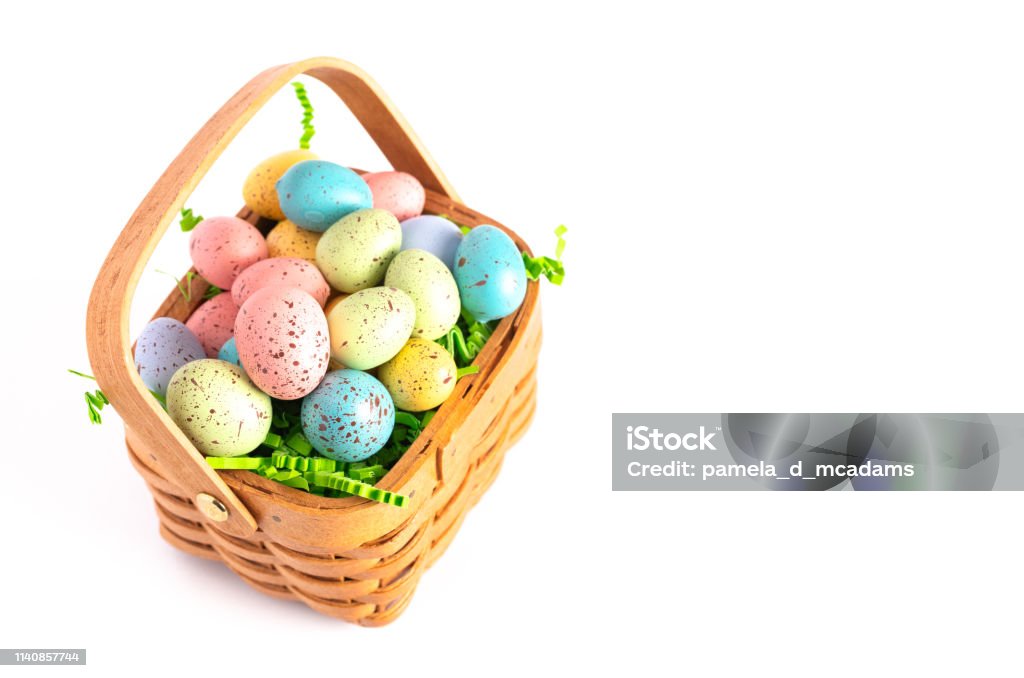 A Wooden Easter Basket Filled with Decorated Eggs Isolated on a White Background Artificial Stock Photo