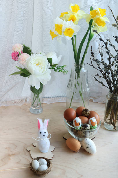 istock A bouquet of flowers and a cup with eggs on a rustic window 1140858733