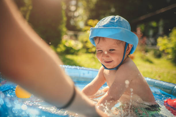 istock Cute little boy having fun in swimming pool at back yard in summer 1140860562