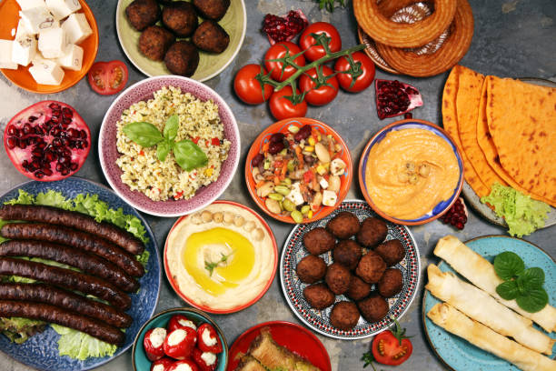 istock Middle eastern or arabic dishes and assorted meze, concrete rustic background. Falafel. Turkish Dessert Baklava with pistachio. Halal food. Lebanese cuisine 1140868967