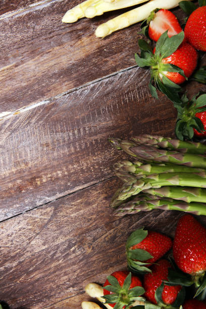 istock White and green asparagus with strawberries on wood 1140870717