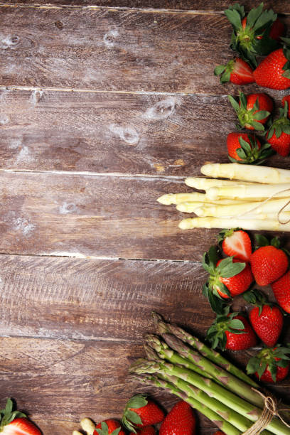 istock White and green asparagus with strawberries on wood 1140870898