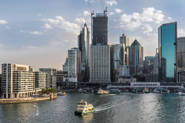 Eastern side of Ferry terminal and Circular Quay Railway station, Sydney Australia. Sydney, Australia - February 12, 2019: Eastern side of Ferry terminal and Circular Quay Railway Station plus skyline in back. Highrises under construction with cranes. Evening shot with light blue sky. ferry terminal audio stock pictures, royalty-free photos & images