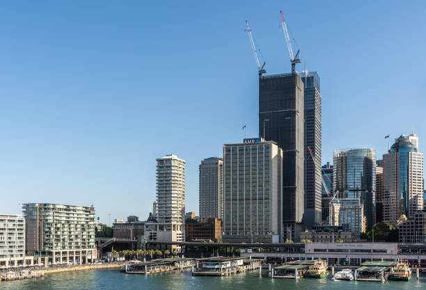 Ferry terminal and Circular Quay Railway station, Sydney Australia. Sydney, Australia - February 12, 2019: Eastern side of ferry terminal and Circular Quay Railway Station plus skyline in back. Highrises under construction with cranes. Evening shot with light blue sky. ferry terminal audio stock pictures, royalty-free photos & images