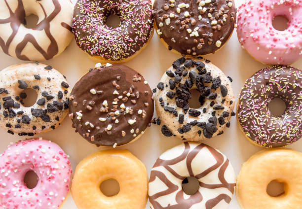 istock Closeup of a dozen decorated donuts 1140880787