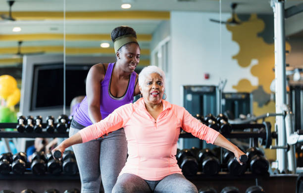 istock Senior woman working out with personal trainer 1140884159