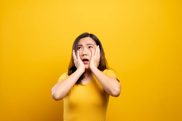 istock Woman feel scared standing isolated over yellow background 1140892995