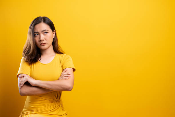 istock Angry woman isolated over yellow background 1140893024