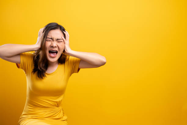 istock Angry woman screaming isolated over yellow background 1140893064