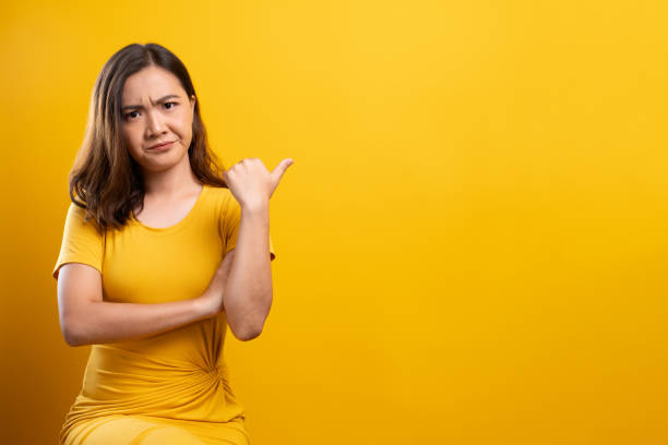 istock Angry woman isolated over yellow background 1140893114