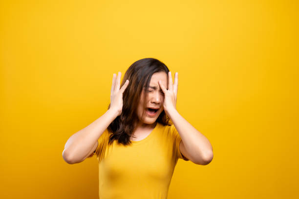 istock Woman feel scared standing isolated over yellow background 1140893632