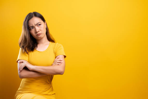 istock Sad woman isolated over yellow background 1140893712