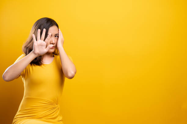 istock Woman feel scared standing isolated over yellow background 1140893806