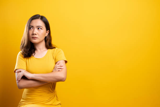 istock Sad woman isolated over yellow background 1140893836