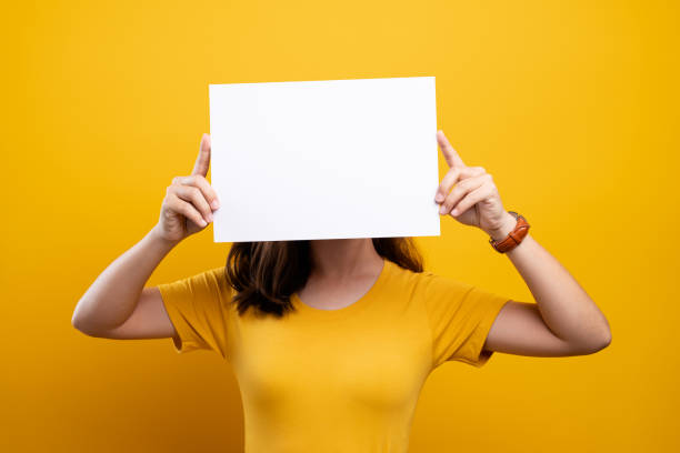 istock Woman covering face with blank paper 1140893857