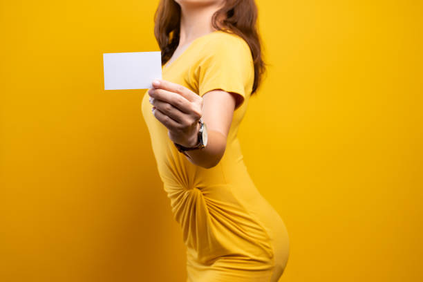 istock Woman holding and showing empty paper card 1140894749