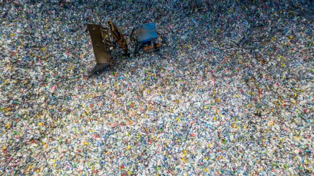 Aerial view large pile of waste plastic bottles in the factory to wait for recycle, Plastic Awareness, Plastic pollution.