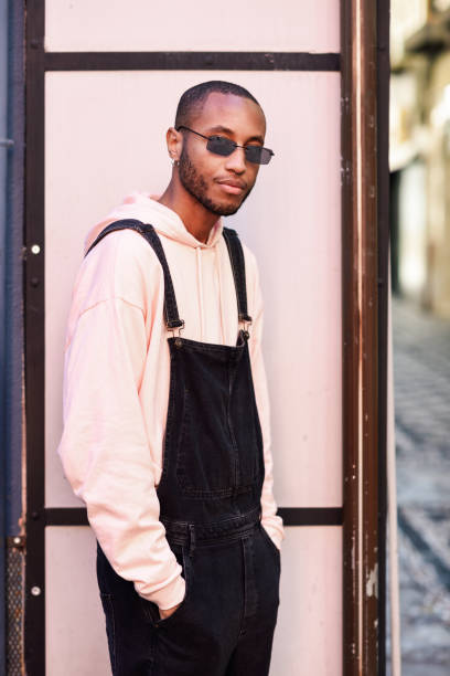 istock African guy with bib pants standing outdoors 1140901391