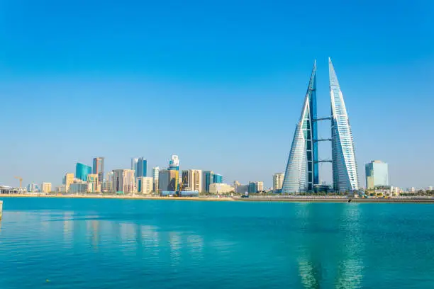 Skyline of Manama dominated by the World trade Center building during night, Bahrain.