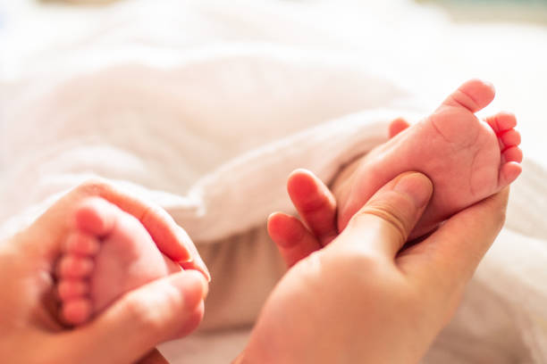 istock Newborn baby foot in mother’s hand 1140904171