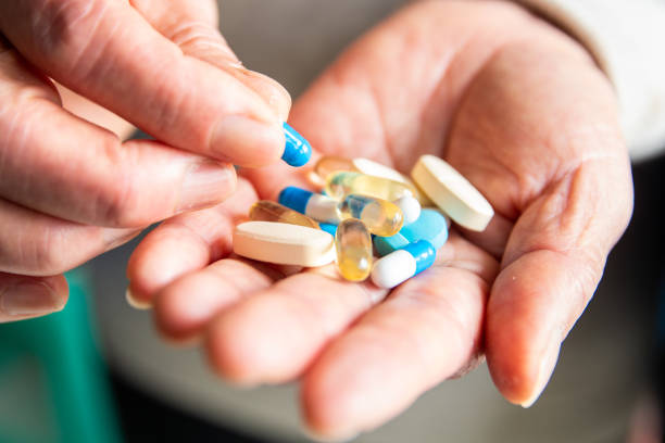 istock Senior woman hand picking pill 1140904406
