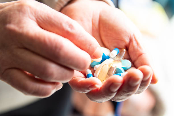 istock Senior woman hand picking pill 1140905360
