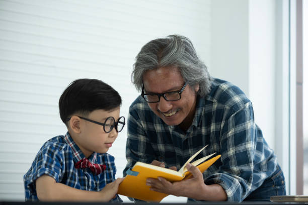 istock Older teachers are teaching students to do homework, education concept 1140905372