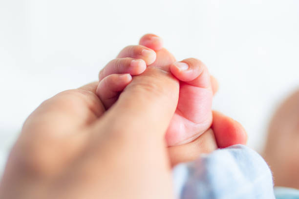 istock Newborn holding father's hand 1140905384
