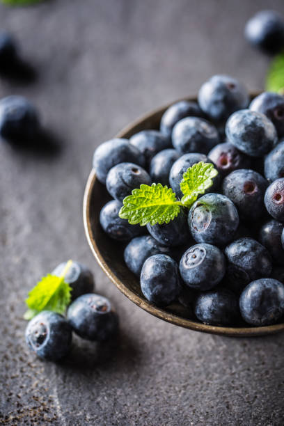 istock Vintage bowl full of fresh blueberries with herbs. 1140909143