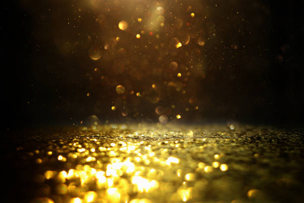 istock glitter vintage lights background. black and gold. de-focused 1140910390
