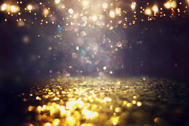 istock glitter vintage lights background. black and gold. de-focused 1140910391