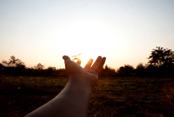 istock Beautiful hand and sunrise down in evening at Thailand. 1140914043