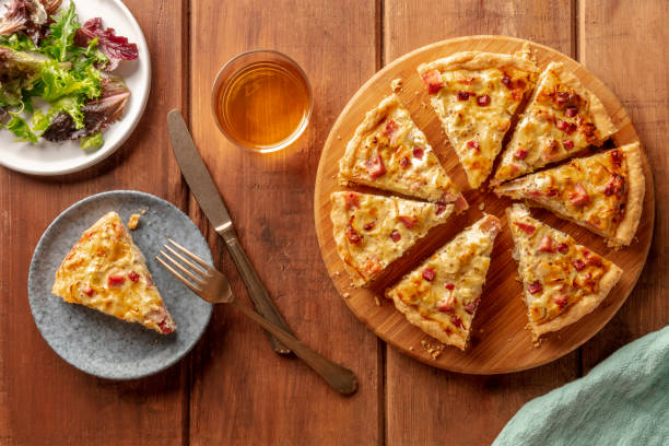 istock French dinner. A quiche with wine and mesclun salad leaves, shot from above on a dark rustic wooden background 1140914061