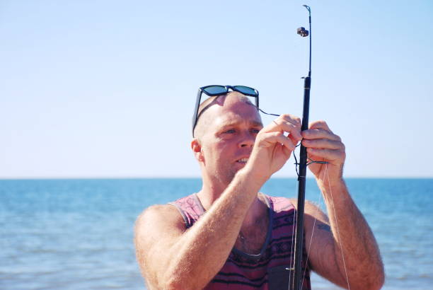 istock A Man Baits Fishing Rod 1140914137