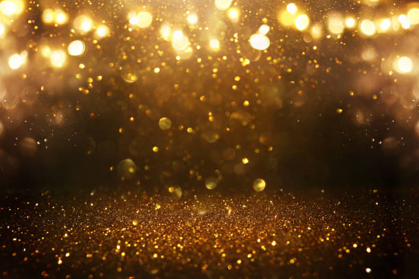istock glitter vintage lights background. black and gold. de-focused 1140914267