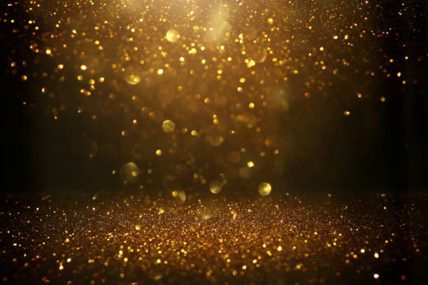 istock glitter vintage lights background. black and gold. de-focused 1140914273