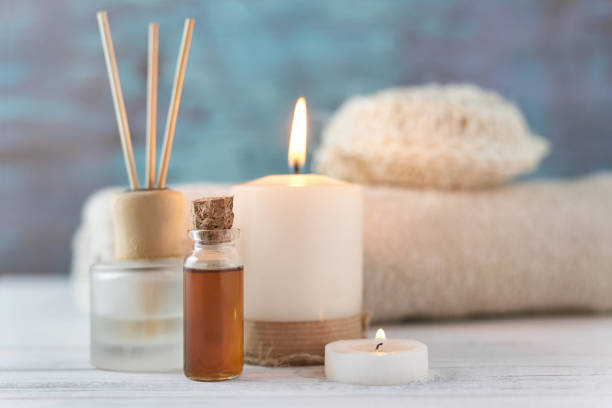 istock Towels, candle and massage oil on white table 1140916996